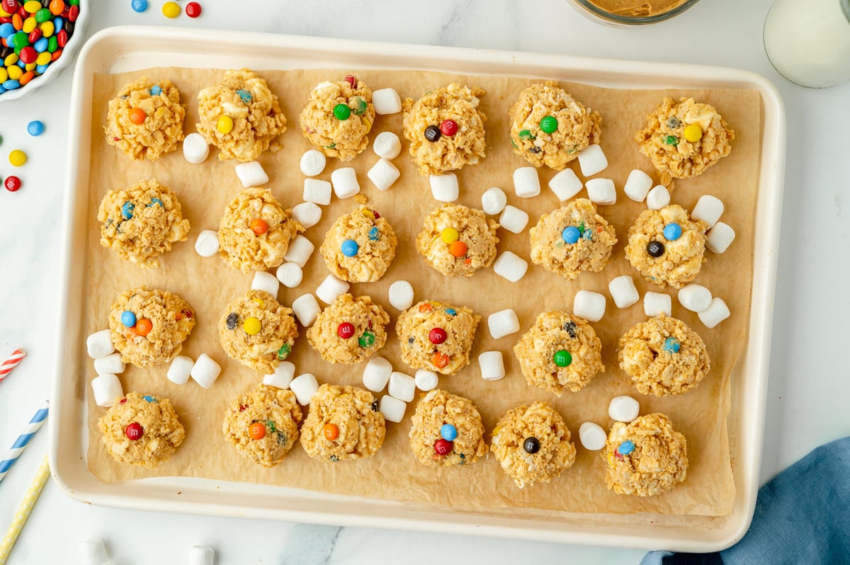 overhead shot of avalanche cookies on baking sheet with marshmallows