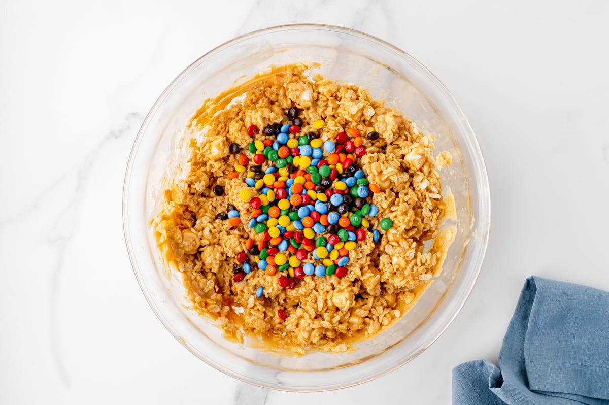 m&ms added to bowl of cookie mixture
