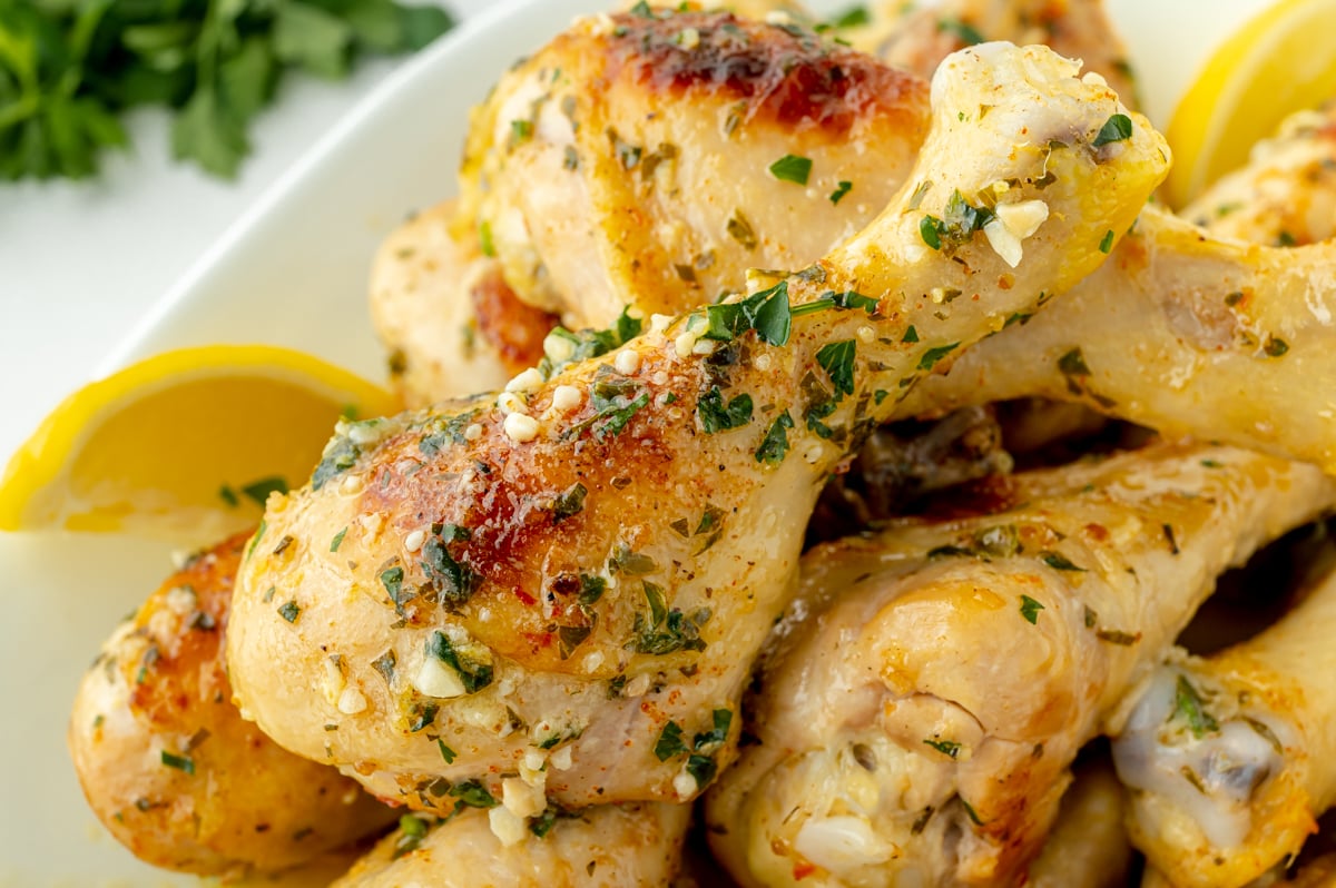 angled shot of platter of baked chicken drumsticks