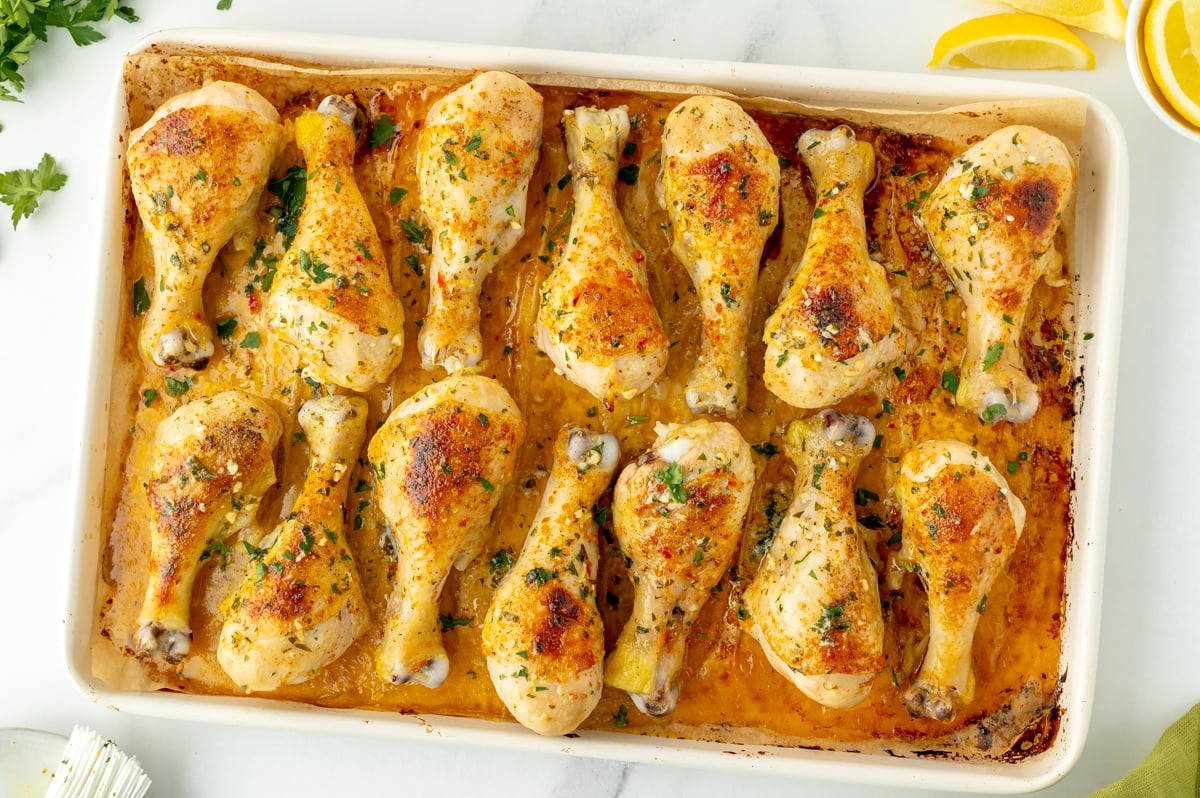 overhead shot of baked chicken drumsticks on sheet pan