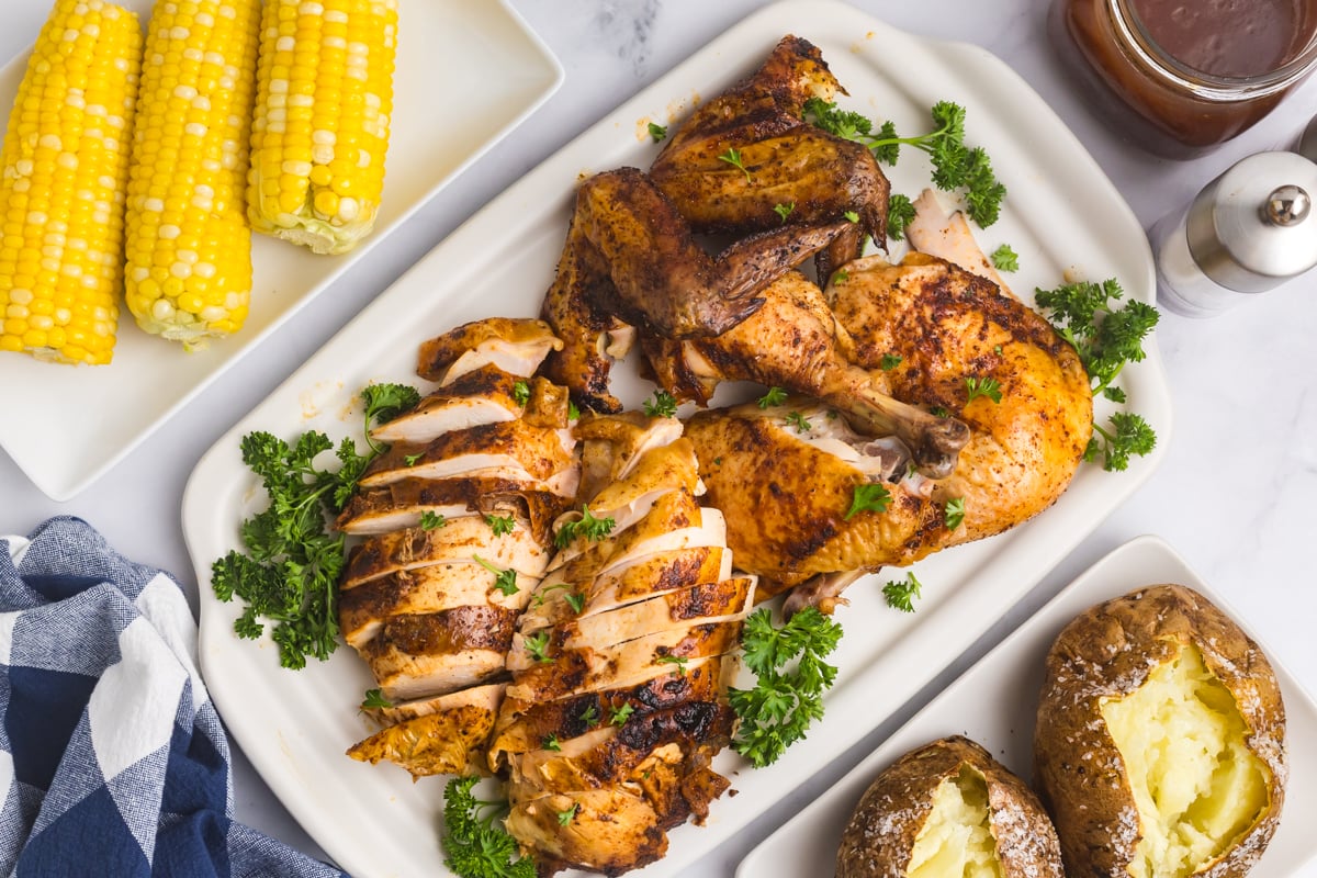 overhead shot of sliced beer can chicken on platter