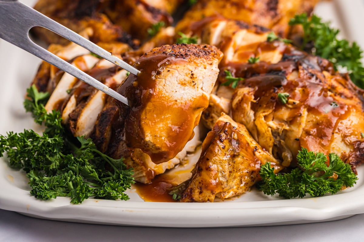 close up of sliced beer can chicken on fork