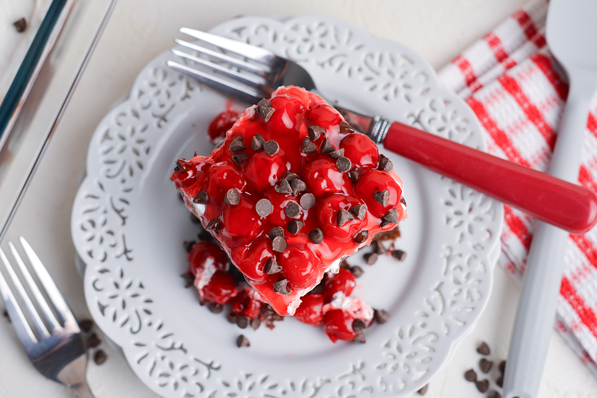 overhead shot of slice of black forest poke cake on plate