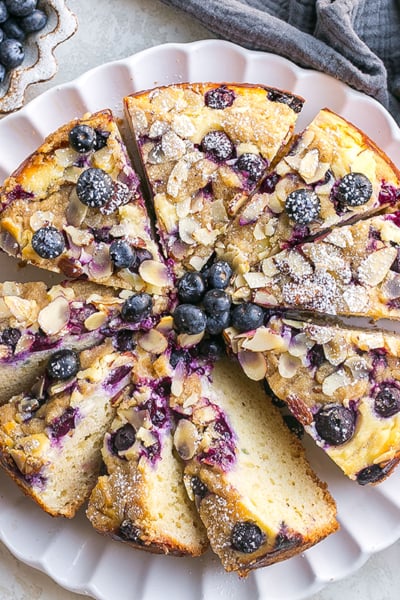 overhead shot of sliced blueberry cream cheese coffee cake on plate
