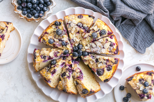 overhead shot of sliced blueberry cream cheese coffee cake on plate