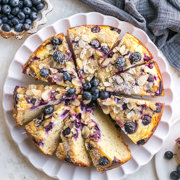 overhead shot of sliced blueberry cream cheese coffee cake on plate