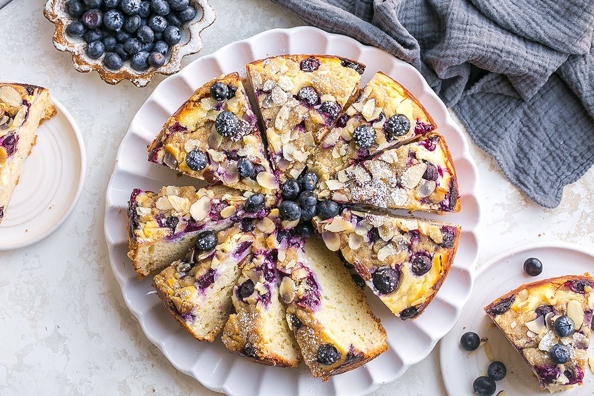 overhead shot of sliced blueberry cream cheese coffee cake on plate