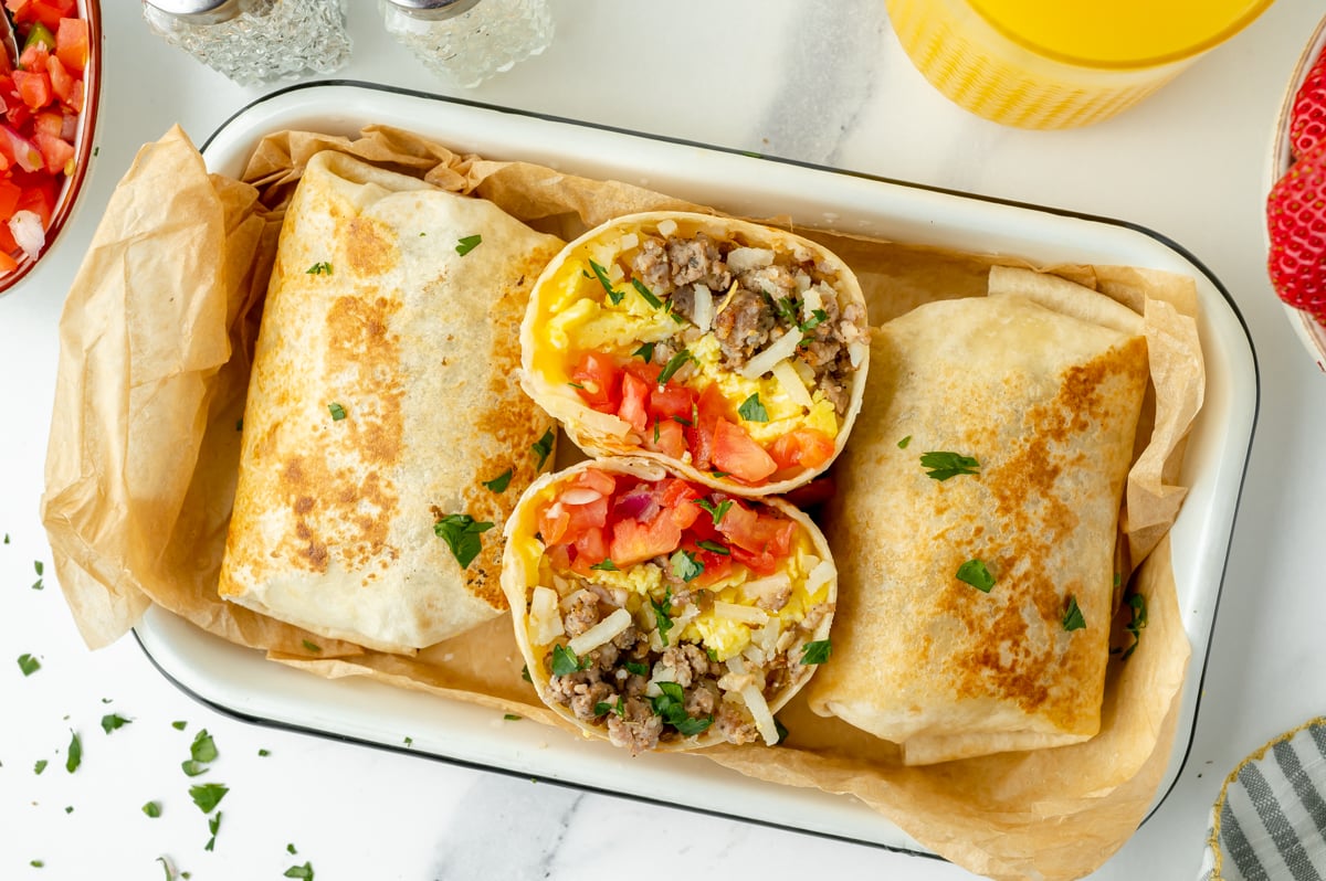overhead shot of breakfast burrito halves in platter