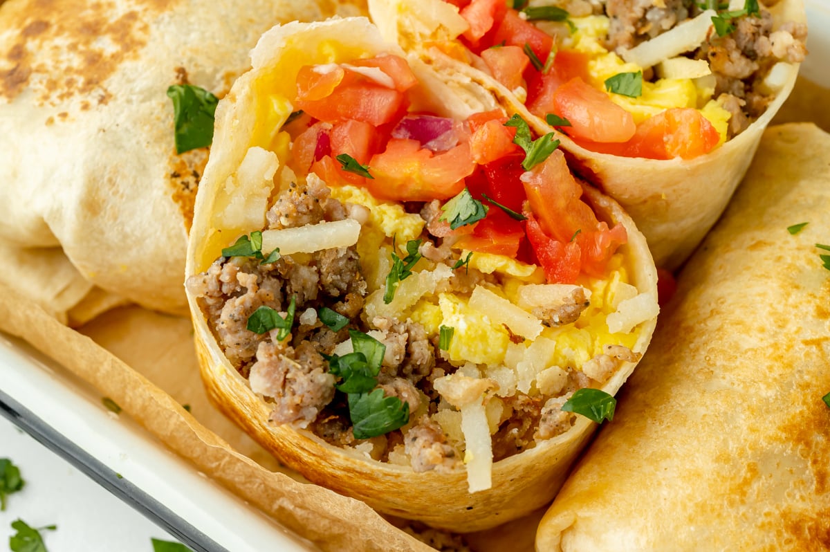 angled shot of breakfast burrito halves in serving dish