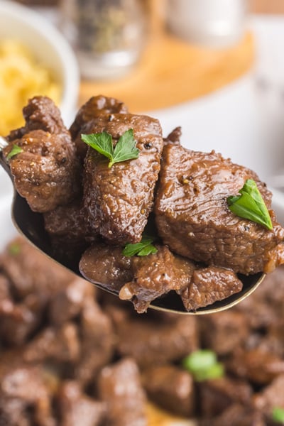 angled shot of brown sugar steak tips on spoon