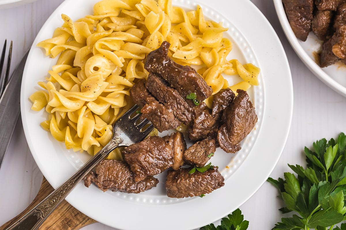 overhead shot of steak tips on fork on plate