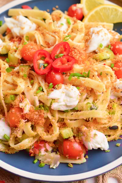 angled shot of plate of creamy chili crab pasta