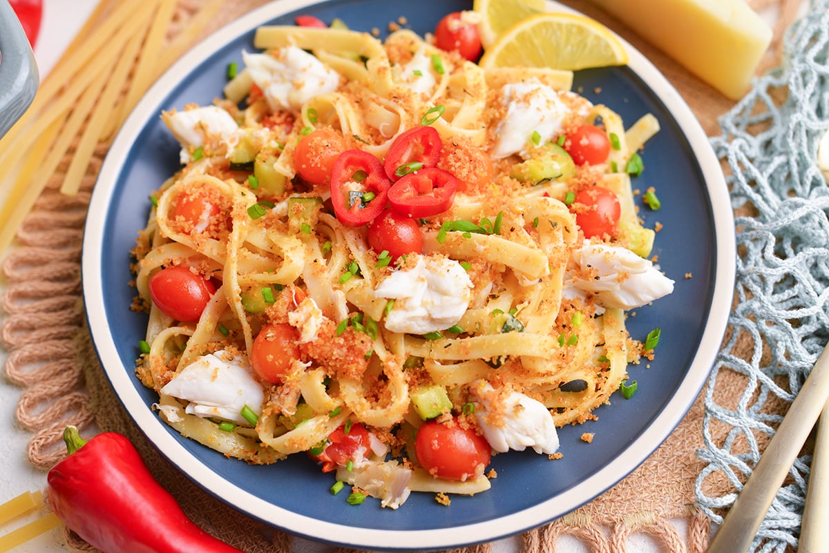 angled shot of plate of creamy chili crab pasta
