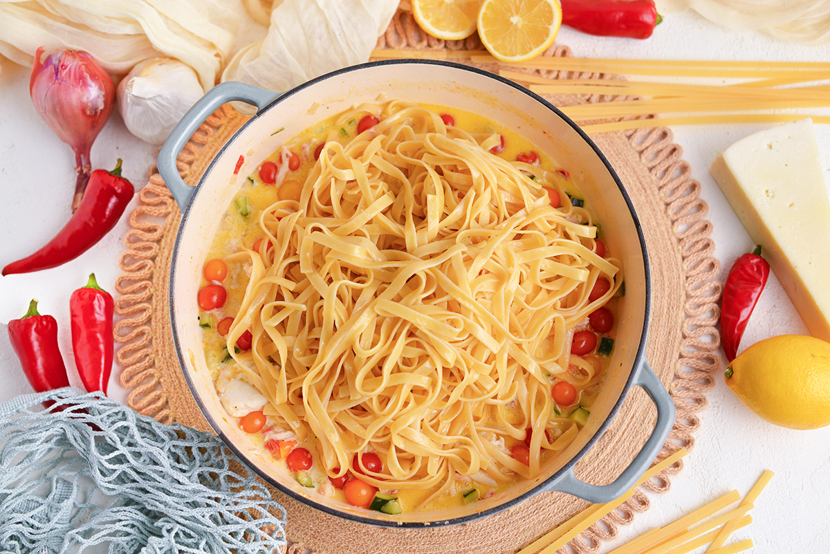 pasta added to pan of sauce
