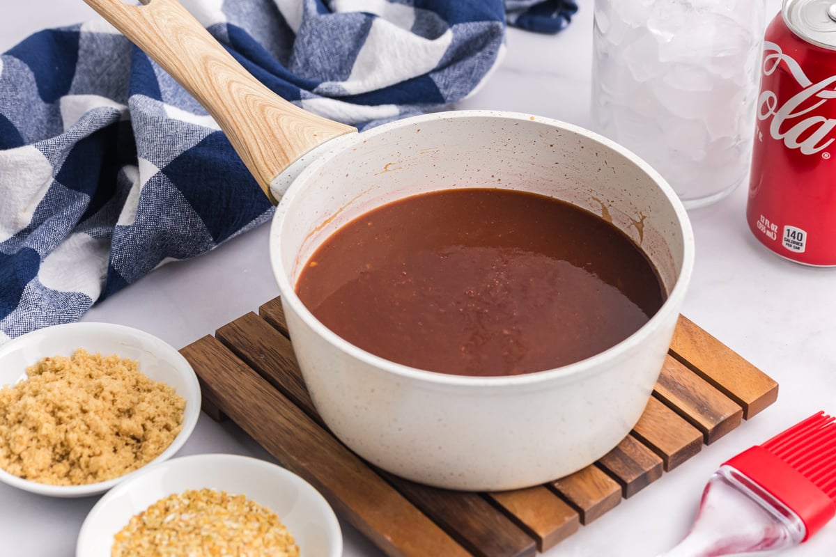 angled shot of saucepan of cola bbq sauce