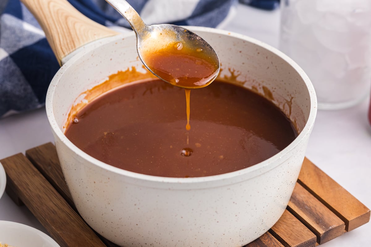 spoon in saucepan of cola bbq sauce