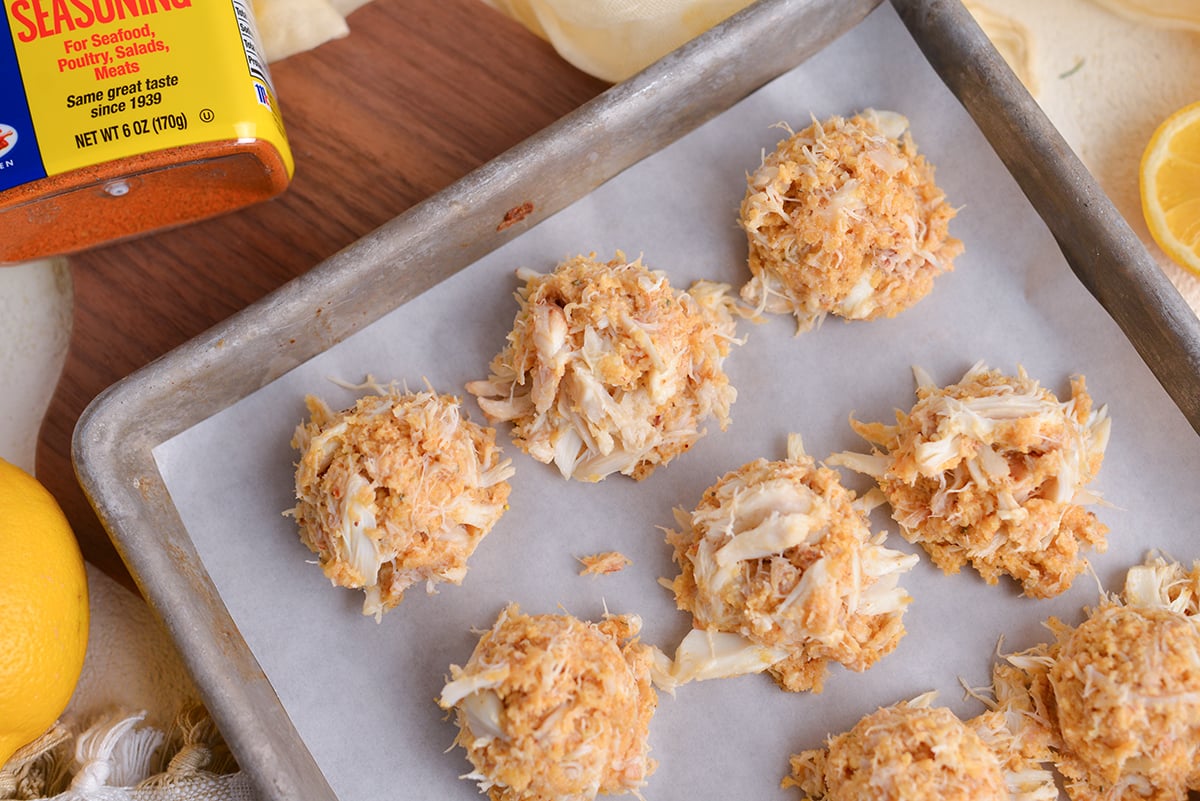 overhead shot of raw crab balls on baking sheet