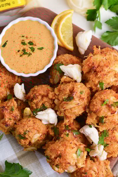 overhead shot of crab balls on tray with lemon and dipping sauce