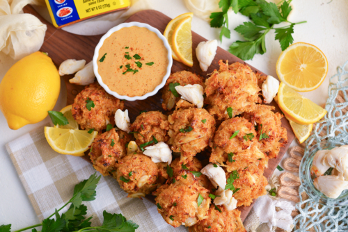 overhead shot of crab balls on tray with lemon and dipping sauce