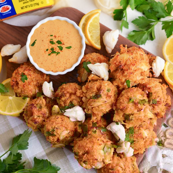 overhead shot of crab balls on tray with lemon and dipping sauce