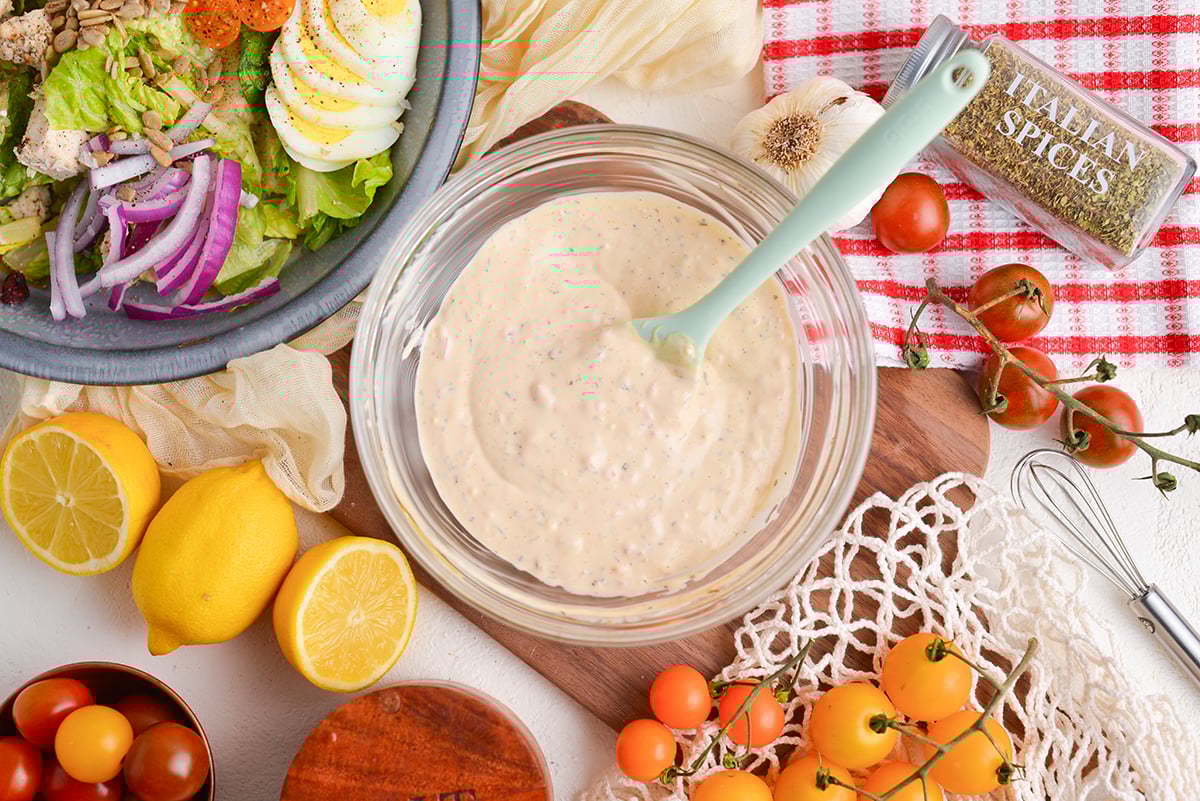 overhead shot of spatula in bowl of creamy italian dressing