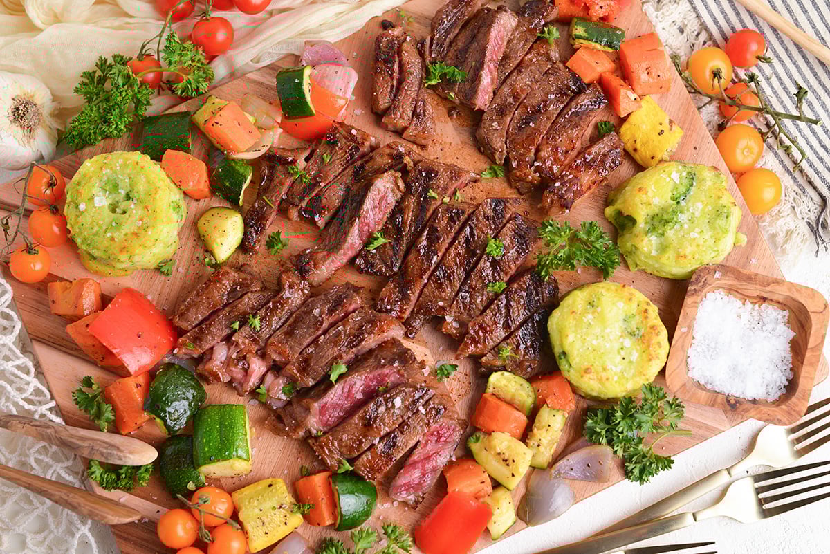 overhead shot of three denver steaks sliced on cutting board