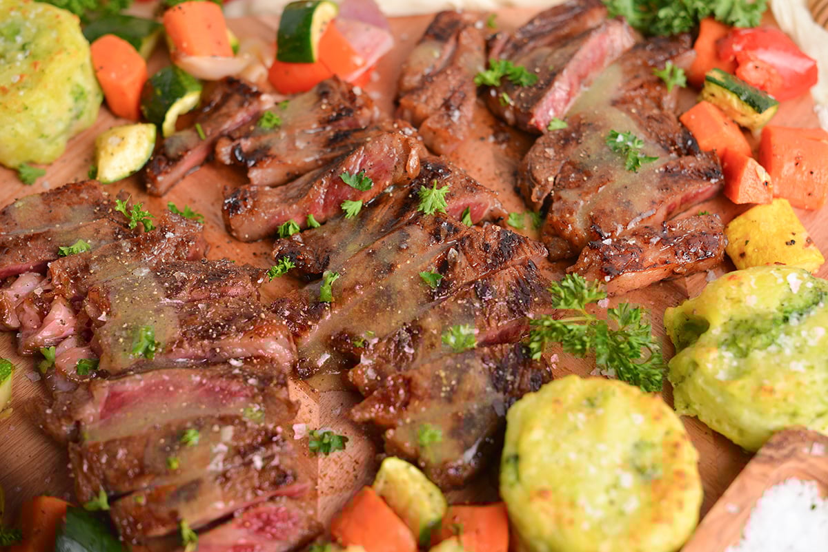 sliced denver steak topped with garlic butter