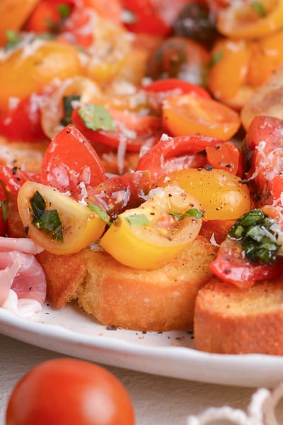 close up angled shot of platter of tomato bruschetta