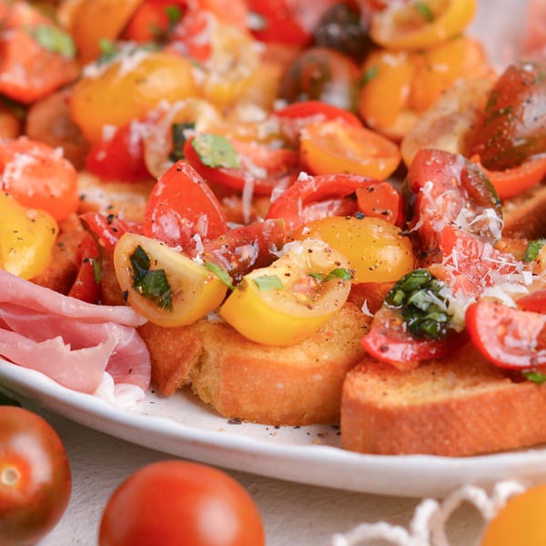 close up angled shot of platter of tomato bruschetta