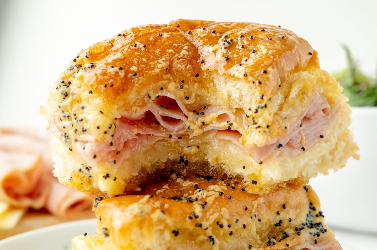 close up of bite taken out of ham and cheese slider