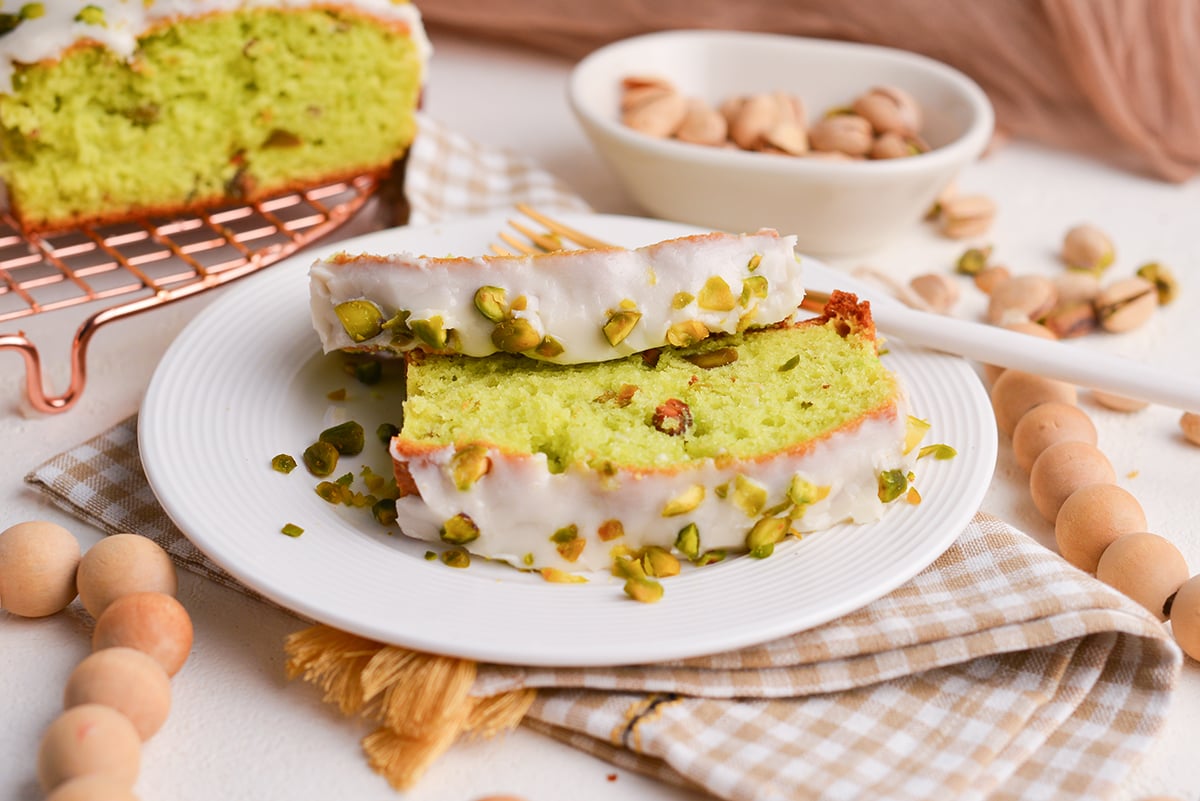 angled shot of two slices of pistachio bread on plate