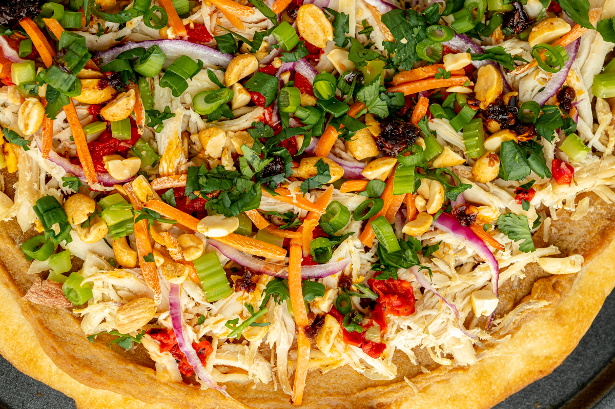 close up overhead shot of thai chicken pizza