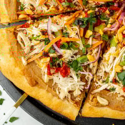close up overhead shot of slice of thai chicken pizza