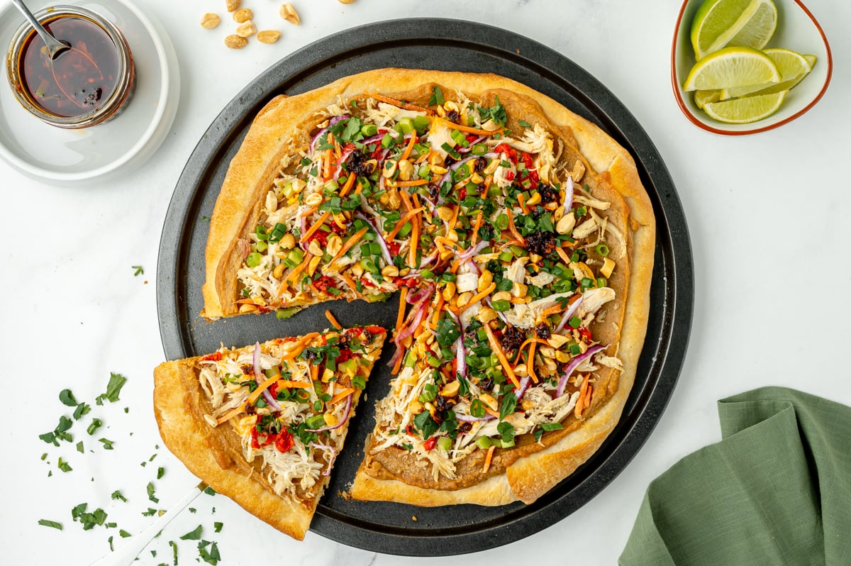 overhead shot of slice of pizza taken out of whole pizza