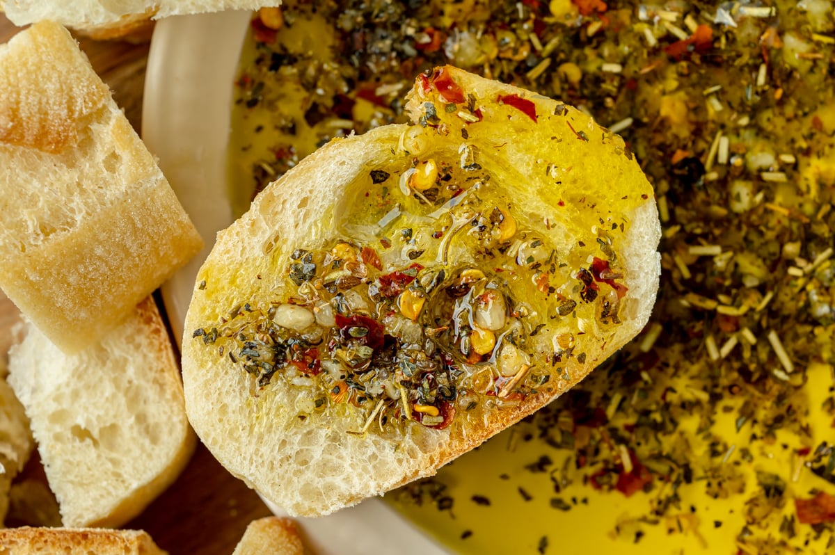 close up overhead shot of bread coated in olive oil bread dip