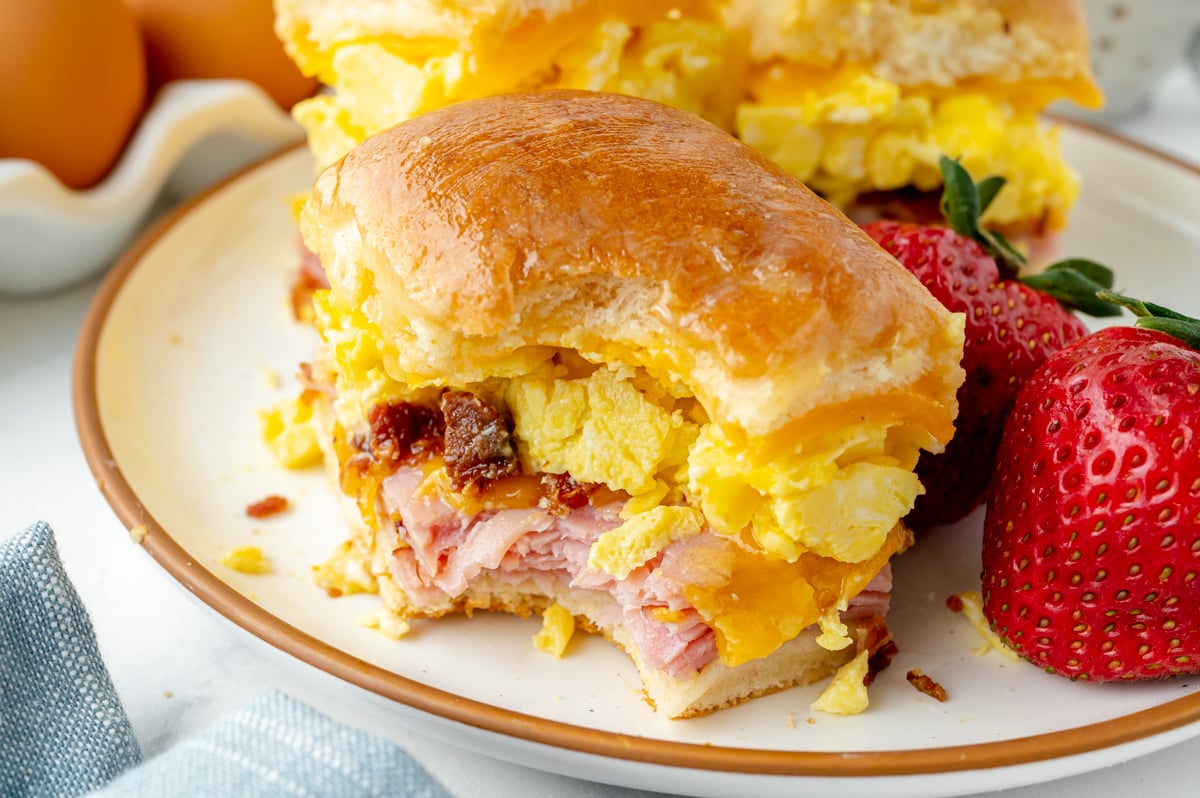angled shot of bite taken out of breakfast slider on plate