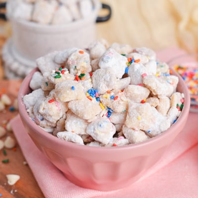 angled shot of pink bowl of cake batter puppy chow