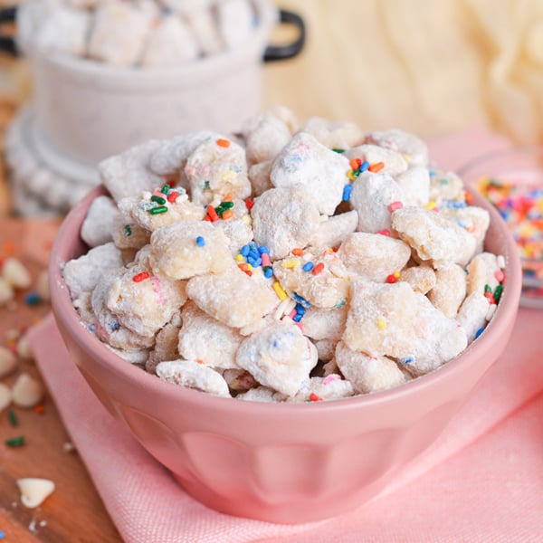 angled shot of pink bowl of cake batter puppy chow
