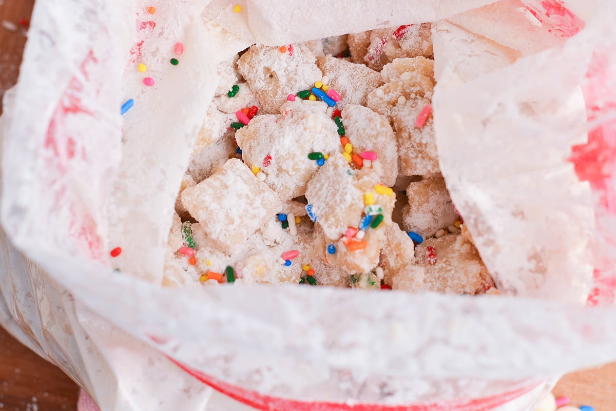 close up shot of cake batter puppy chow in ziplock bag