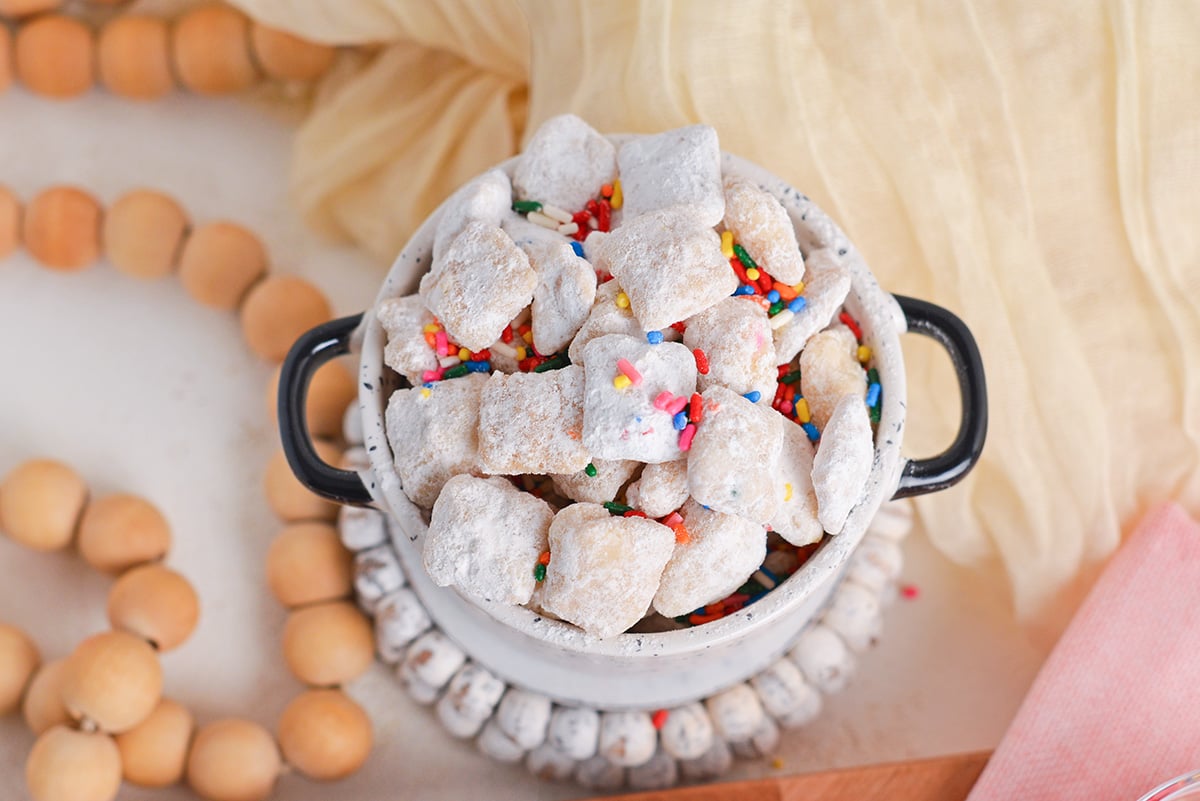 overhead shot of birthday cake puppy chow in white bowl