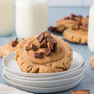 angled shot of reeses peanut butter cookie on stack of plates