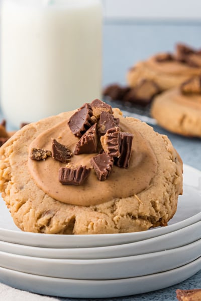 angled shot of reeses peanut butter cookie on stack of plates