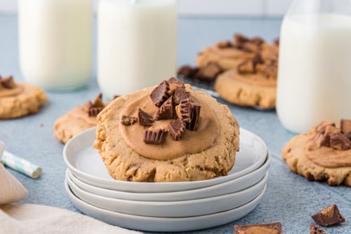 angled shot of reeses peanut butter cookie on stack of plates