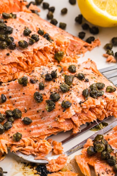 angled shot of piece of lemon salmon on spatula