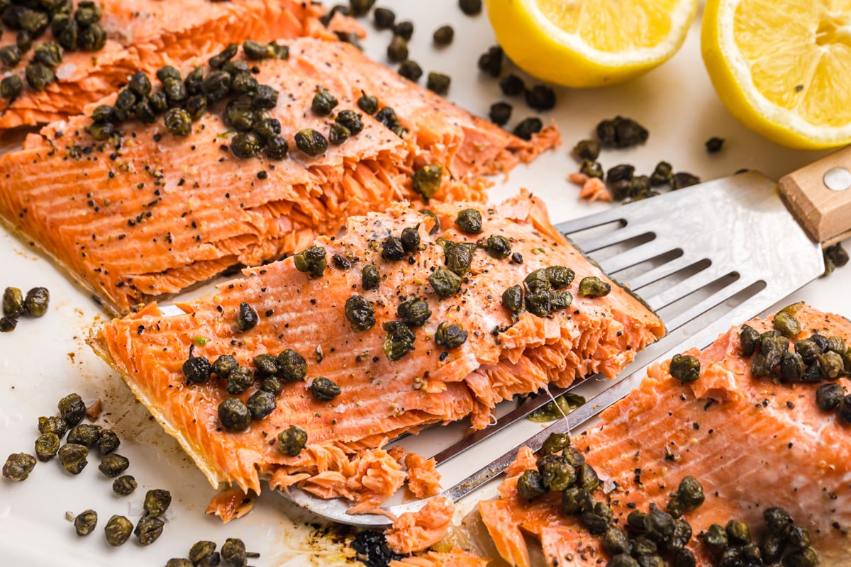 angled shot of piece of lemon salmon on spatula