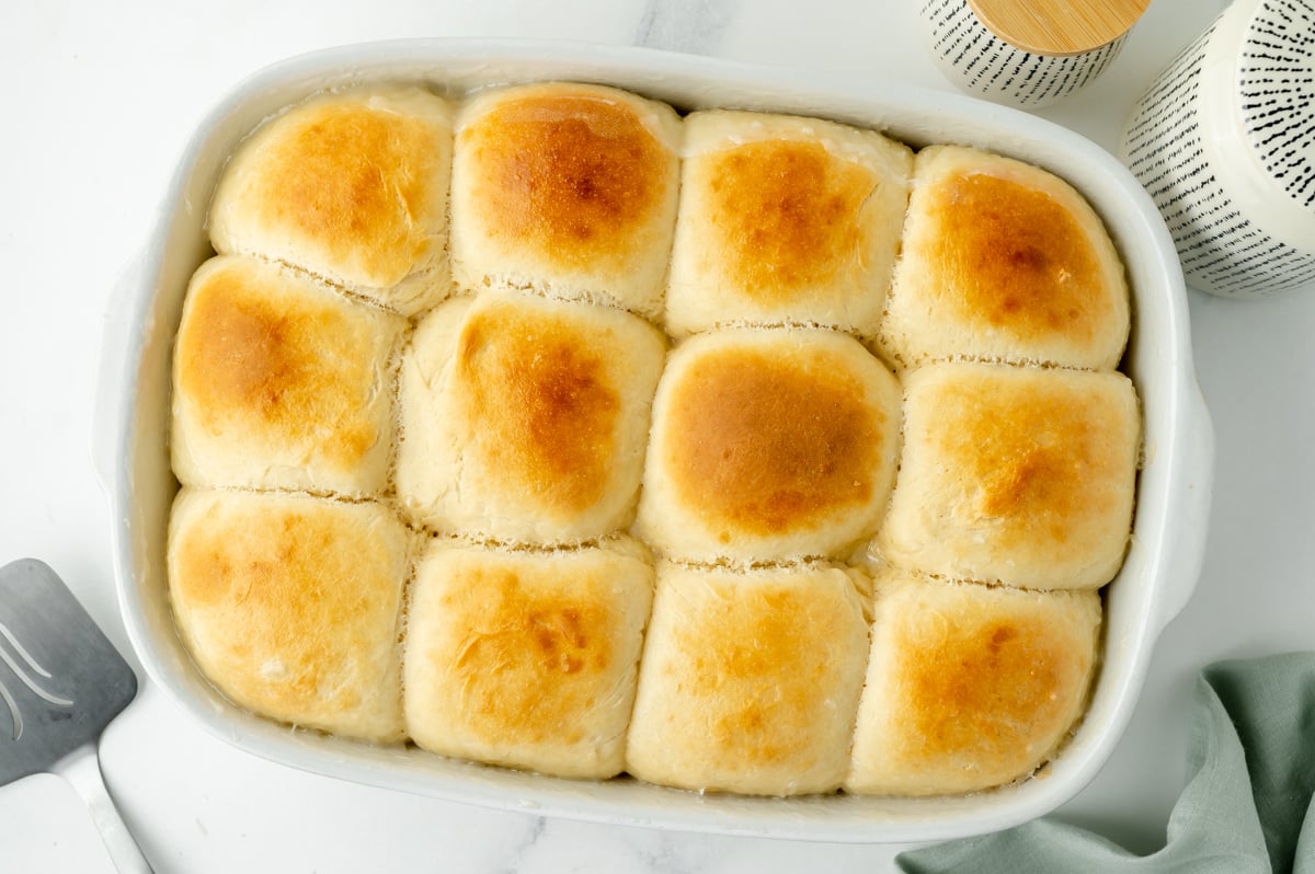 overhead shot of baked pani popo rolls in baking dish