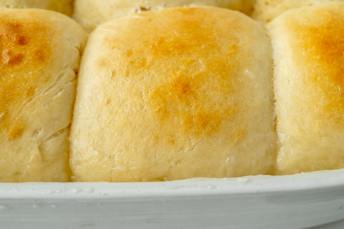 close up angled shot of pani popo coconut rolls in baking dish