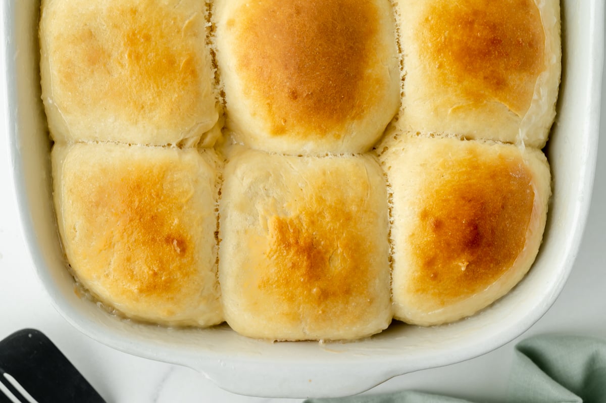 overhead shot of half a pan of pani popo coconut rolls