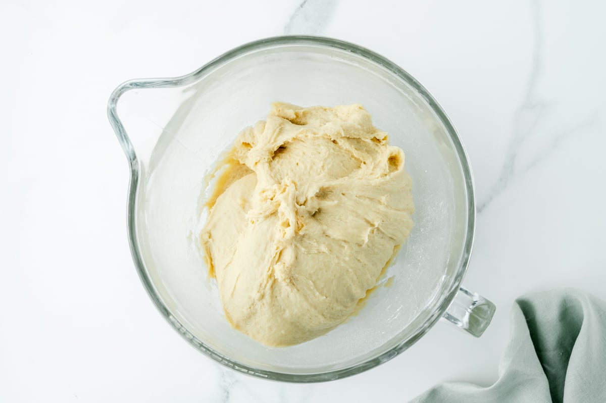 overhead shot of bread dough in mixing bowl