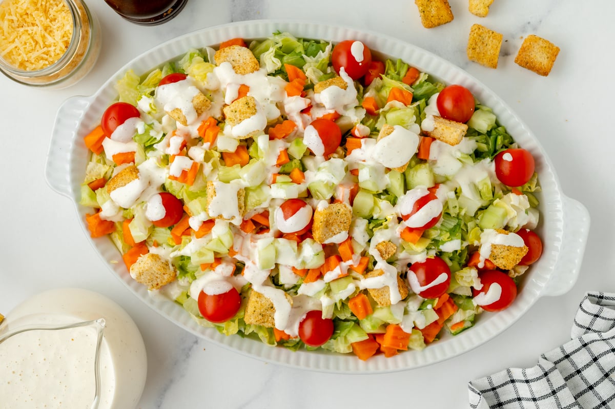 overhead shot of platter of salad topped with Parmesan Peppercorn Dressing